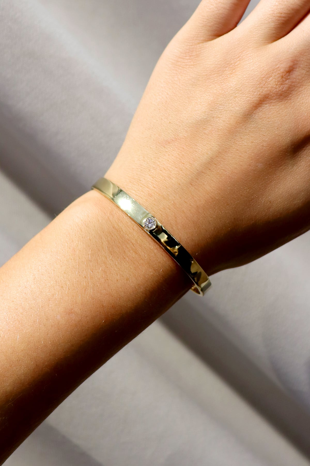 Single Diamond Set Bangle In 9 Carat Yellow Gold available from LeGassick Fine Jewellery, Gold Coast, Australia. Showrooms at Pacific Fair and Runaway Bay Centre.
