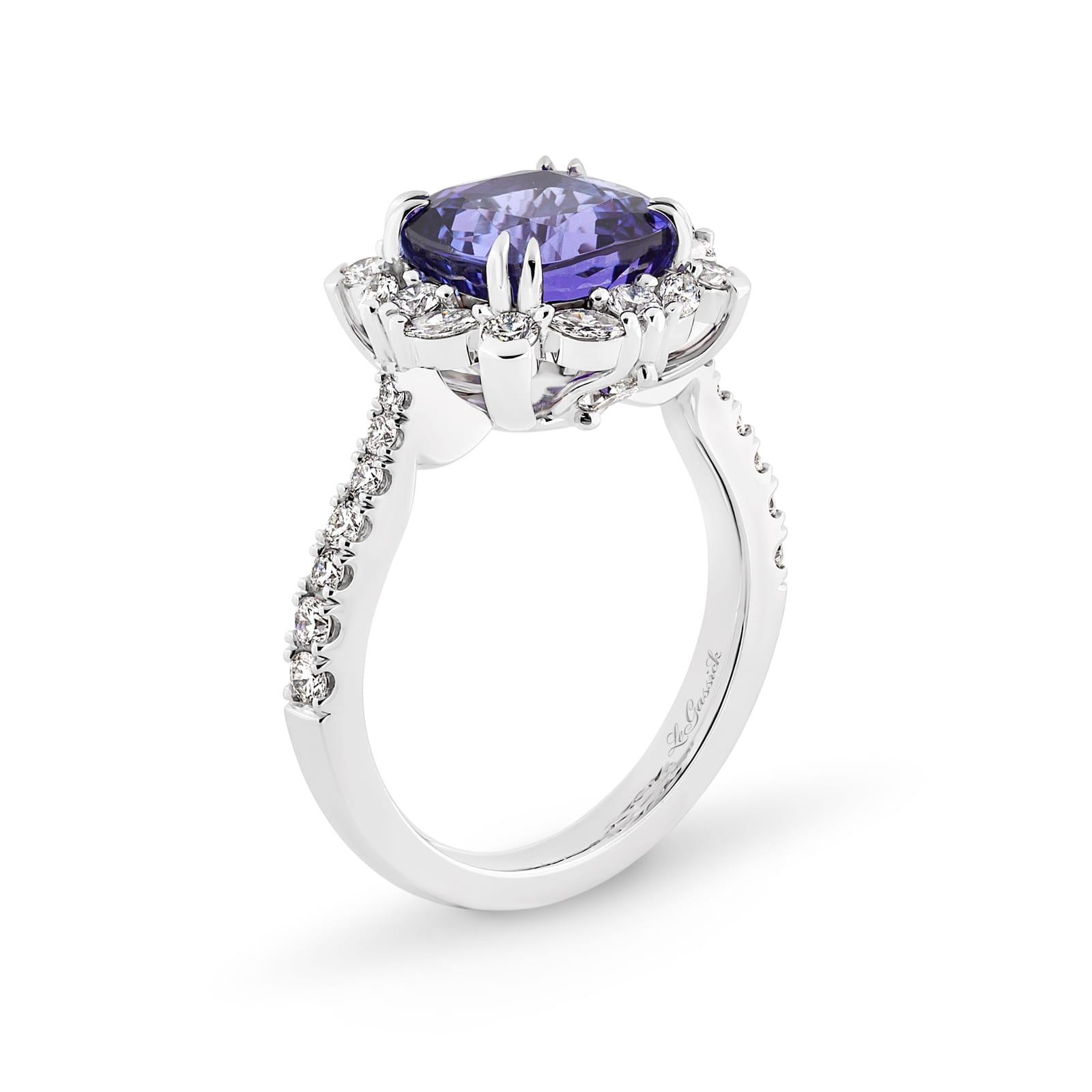Violetta has a 4.06 carat cushion-cut tanzanite centre surrounded by a halo of alternating white round brilliant cut and marquise cut diamonds. Featuring 2 marquise cut diamonds underneath the ring and 14 round white diamonds on the band. She was designed and handcrafted by LeGassick's Master Jewellers, Gold Coast, Australia.