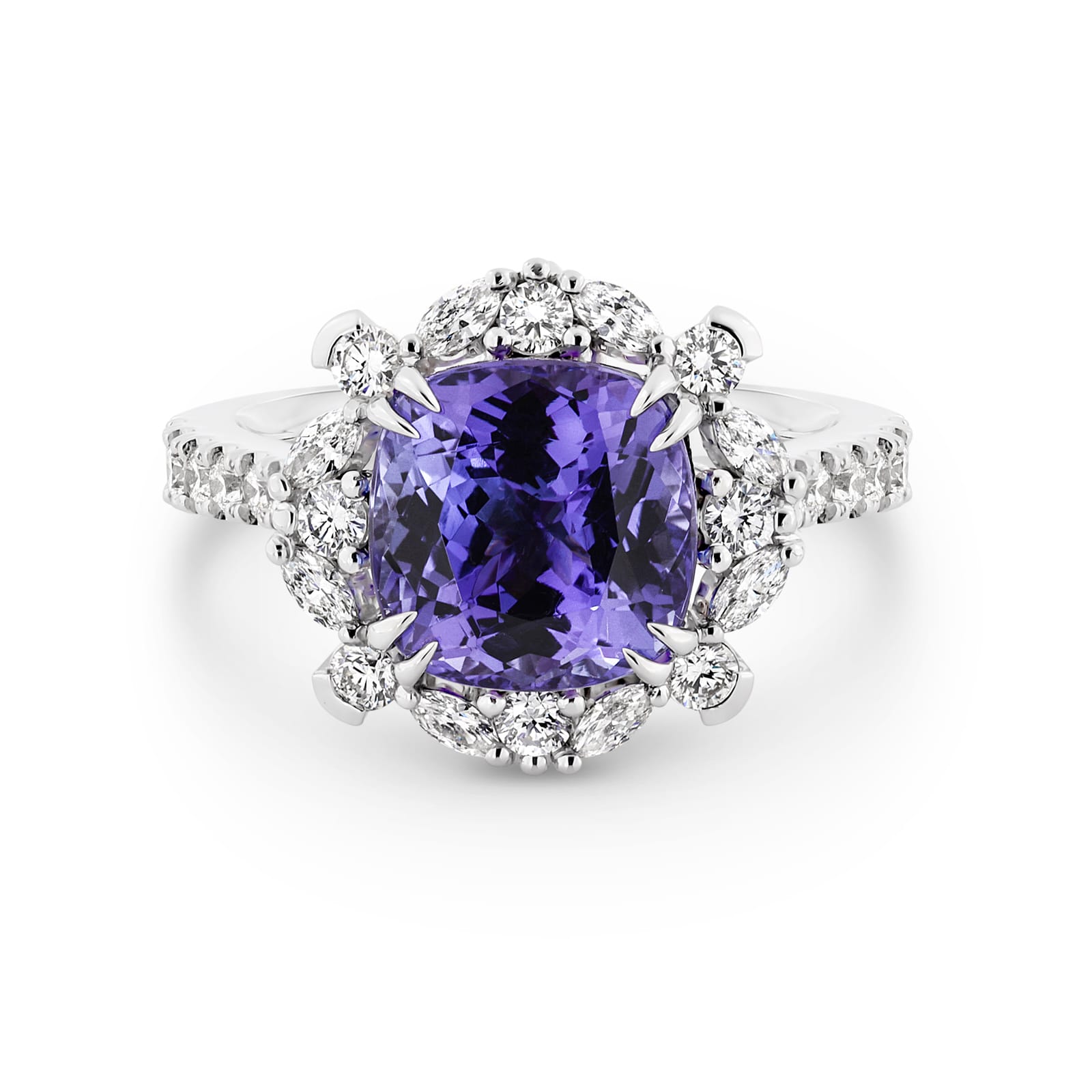 Violetta has a 4.06 carat cushion-cut tanzanite centre surrounded by a halo of alternating white round brilliant cut and marquise cut diamonds. Featuring 2 marquise cut diamonds underneath the ring and 14 round white diamonds on the band. She was designed and handcrafted by LeGassick's Master Jewellers, Gold Coast, Australia.