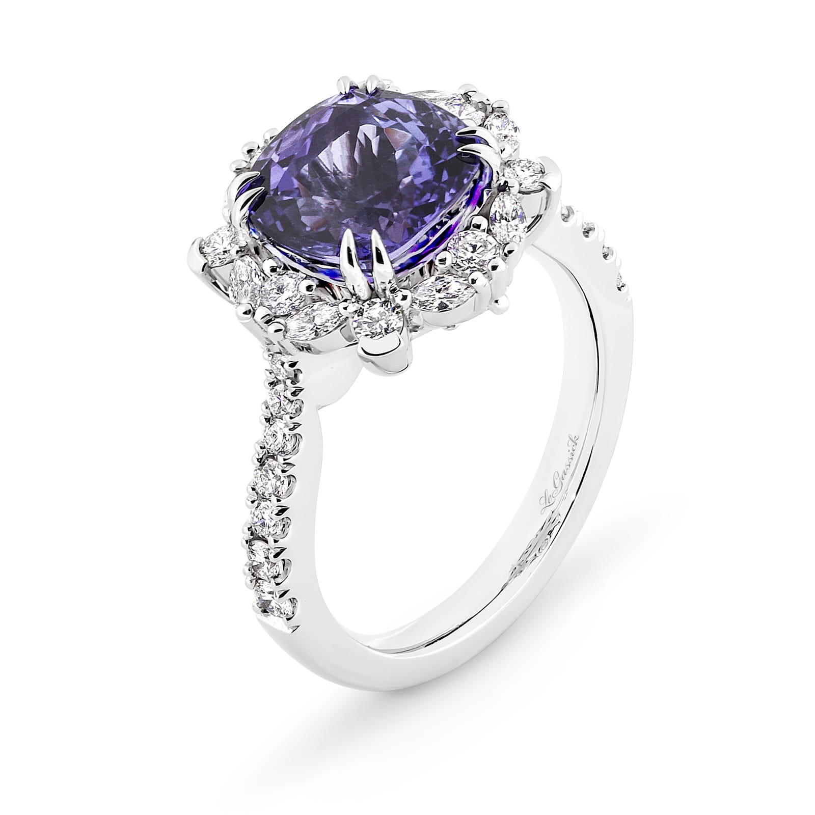 Violetta has a 4.06 carat cushion-cut tanzanite centre surrounded by a halo of alternating white round brilliant cut and marquise cut diamonds. Featuring 2 marquise cut diamonds underneath the ring and 14 round white diamonds on the band. She was designed and handcrafted by LeGassick's Master Jewellers, Gold Coast, Australia.