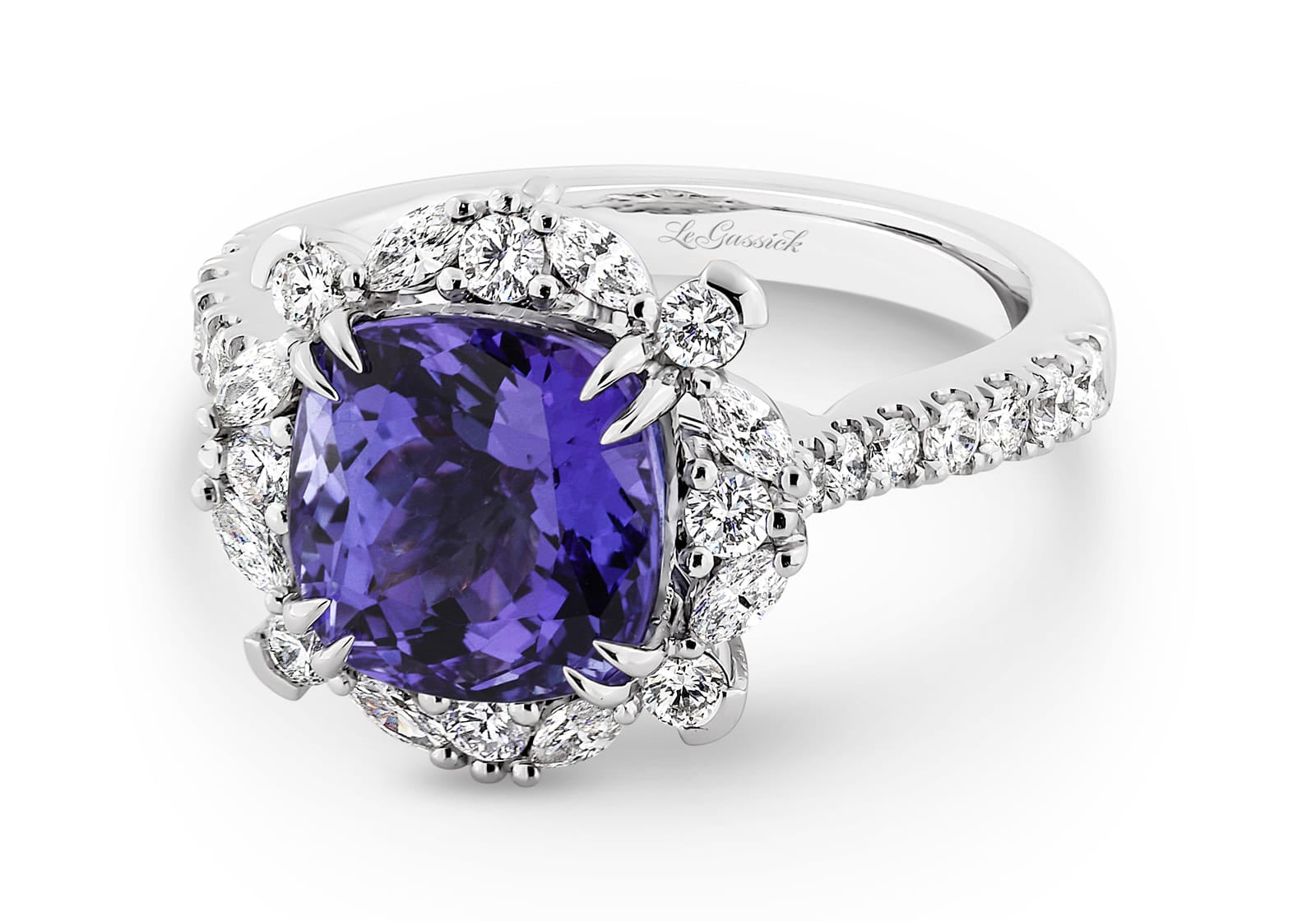 Violetta has a 4.06 carat cushion-cut tanzanite centre surrounded by a halo of alternating white round brilliant cut and marquise cut diamonds. Featuring 2 marquise cut diamonds underneath the ring and 14 round white diamonds on the band. She was designed and handcrafted by LeGassick's Master Jewellers, Gold Coast, Australia.