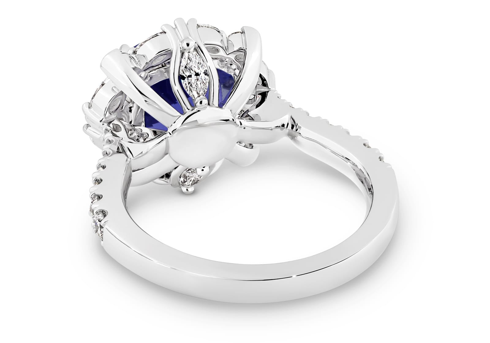 Violetta has a 4.06 carat cushion-cut tanzanite centre surrounded by a halo of alternating white round brilliant cut and marquise cut diamonds. Featuring 2 marquise cut diamonds underneath the ring and 14 round white diamonds on the band. She was designed and handcrafted by LeGassick's Master Jewellers, Gold Coast, Australia.