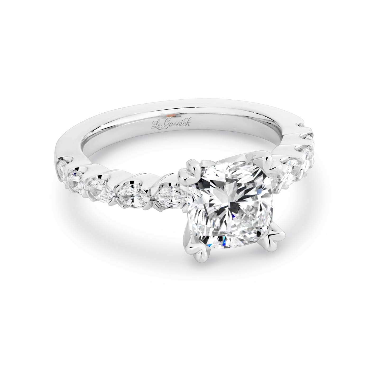 Grace has a 2.04 carat cushion-cut solitaire featuring 10 white oval cut diamonds on the band. Grace also features a natural Argyle pink diamond that has been nestled under her setting. She was designed and handcrafted by LeGassick's Master Jewellers, Gold Coast, Australia.