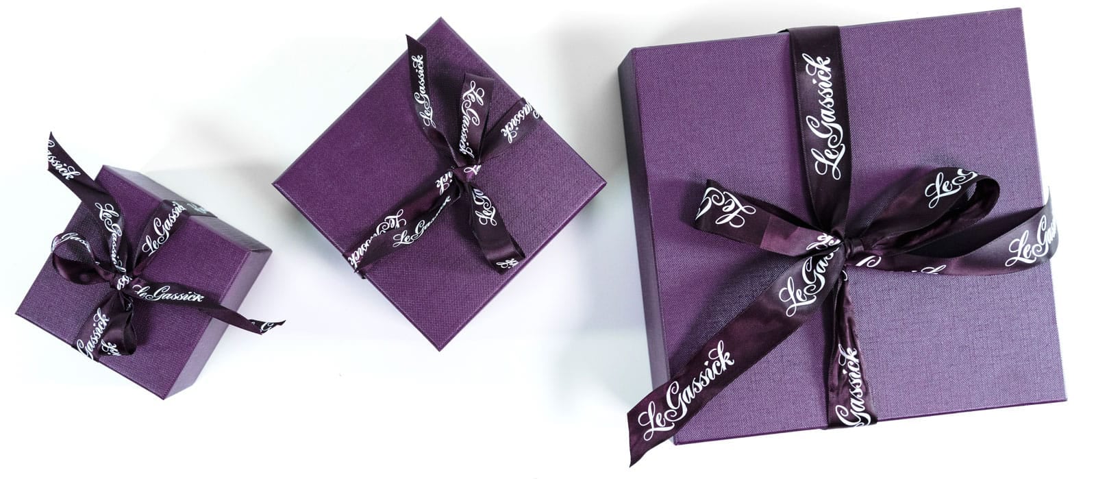 Purple jewellery boxes wrapped with ribbon from LeGassick Diamonds and Jewellery Gold Coast, Australia.