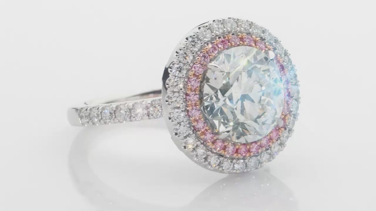 Cleopatra has a stunning 4.51ct round brilliant cut centre diamond surrounded by an inner halo of 24 rare, natural Argyle pink diamonds that, in turn, are showcased by an outer halo of fine white diamonds. She was designed and handcrafted by LeGassick's Master Jewellers, Gold Coast, Australia.