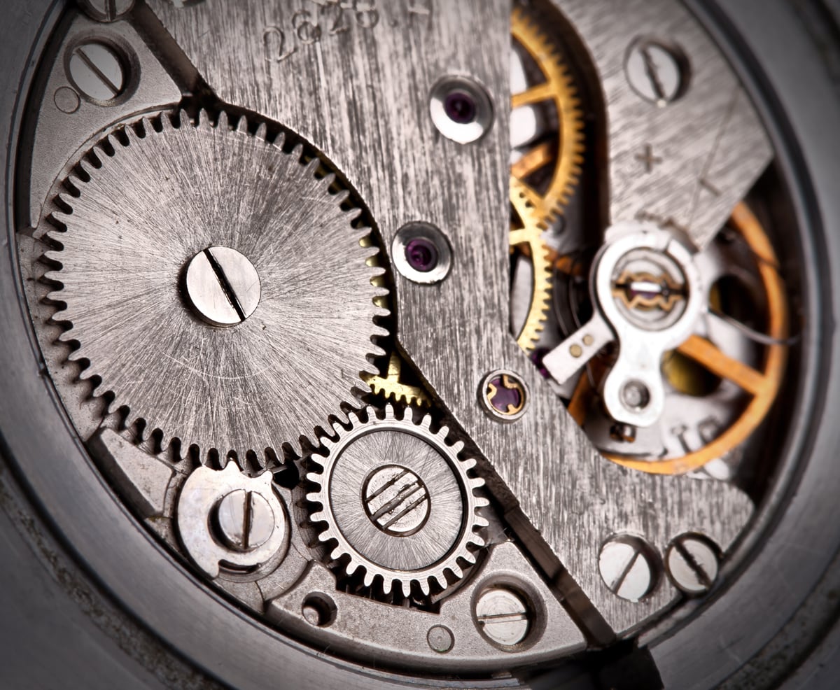 Close-up of a mechanical watch movement with gears and components at LeGassick.