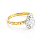 Gold ring with a diamond halo on a white background