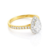 Gold ring with a diamond halo on a white background