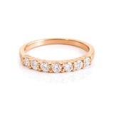 Rose gold ring with diamonds on a white background