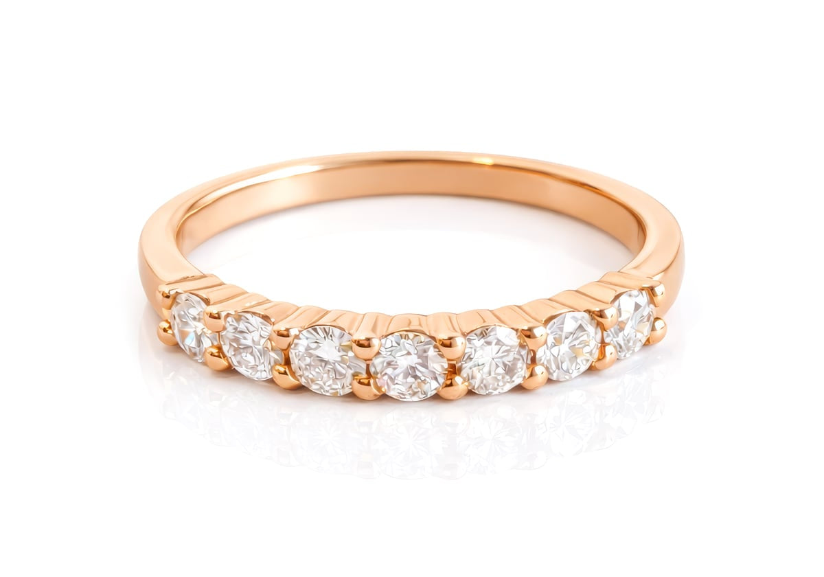 Rose gold ring with diamonds on a white background