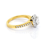 Gold ring with a diamond halo on a white background