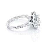 Diamond ring with a pear-shaped centre stone and diamond halo on a white background