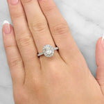Lady wearing a 0.70ct Oval Diamond Halo Ring in 18ct White Gold