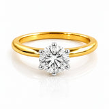 Gold ring with a diamond on a white background