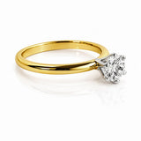 Gold ring with a diamond on a white background