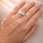 5 Stone gold and lab diamond ring on a a lady's hand
