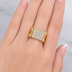 Gold ring with diamonds on a hand against a light background at LeGassick Showroom.