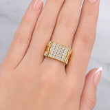 Gold ring with diamonds on a hand against a light background at LeGassick Showroom.