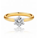 Gold ring with a diamond on a white background