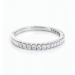 White Gold band with small diamonds on a white background