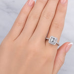 Hand wearing a diamond ring on a neutral background at LeGassick.
