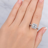 Hand wearing a diamond ring on a neutral background at LeGassick.