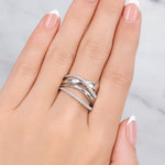 Hand wearing two silver rings with a light background at LeGassick