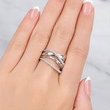 Hand wearing two silver rings with a light background at LeGassick