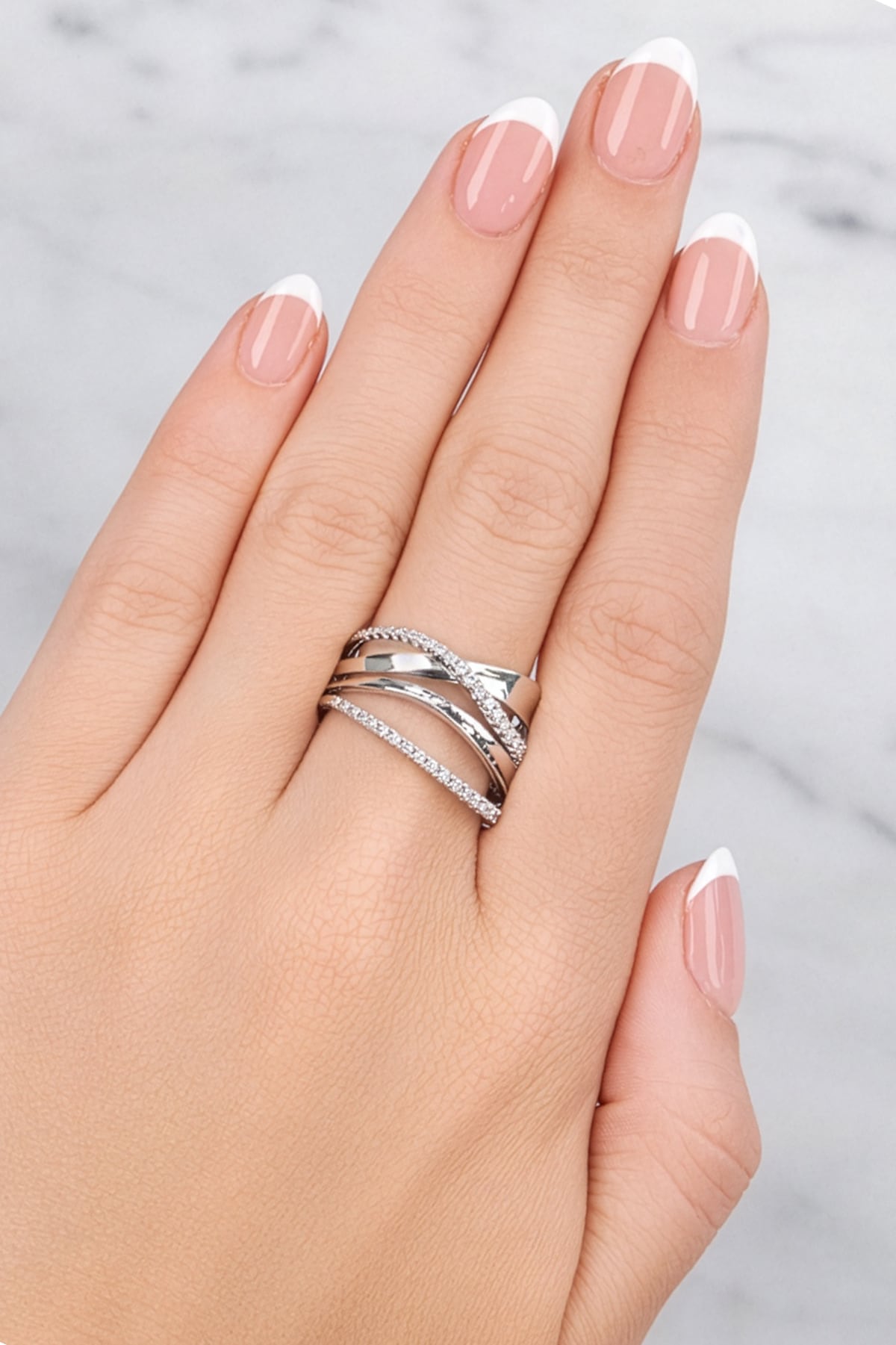 Hand wearing two silver rings with a light background at LeGassick