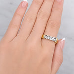 Hand wearing a gold and silver ring on a neutral background at LeGassick.