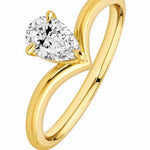 Gold ring with a pear-shaped diamond on a white background