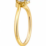 Gold ring with a pear-shaped diamond on a white background