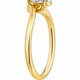 Gold ring with a pear-shaped diamond on a white background