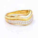 Gold ring with diamond accents on a white background