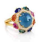 Luxury ring with a blue gemstone and multicolored stones on a white background