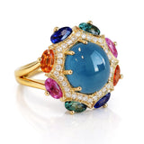 Luxury ring with a blue gemstone and multicolored stones on a white background
