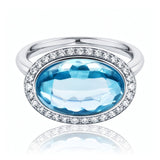 Blue Topaz & Diamond Halo Ring set in 18ct White Gold from LeGassick.