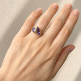 Hand wearing a Amethyst Toi et Moi Yellow Gold Ring on beige background