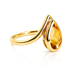 Pear Cut Bezel Set Citrine Ring in Yellow Gold on a white background