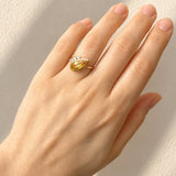 Hand wearing a Citrine & Diamond Dress Ring in Yellow Gold on a light background