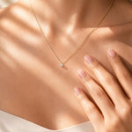 Diamond Solitaire Pendant on a white gold chain on a lady's torso