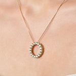 Necklace with a circular pendant on a person's neck