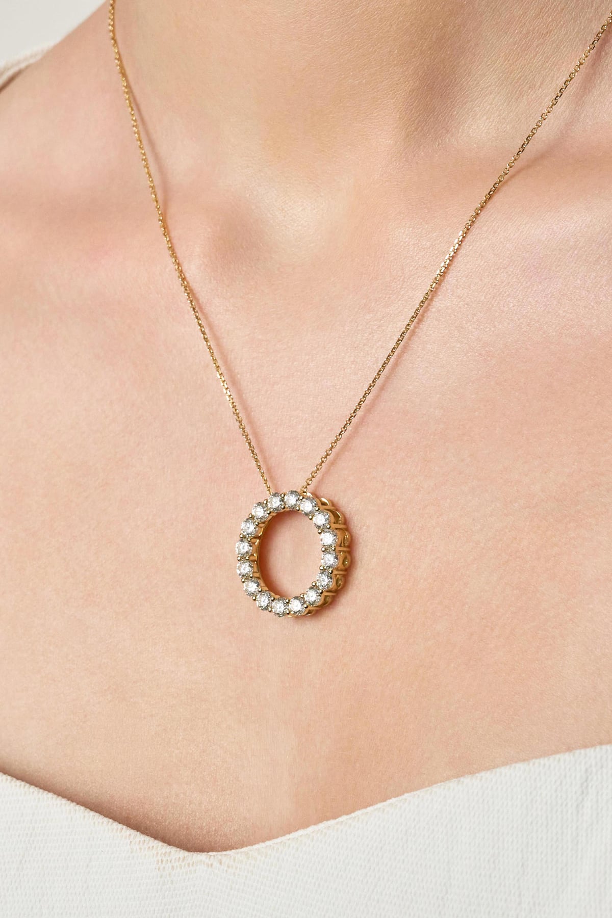 Necklace with a circular pendant on a person's neck