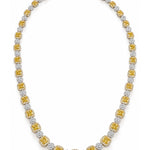 Luxury 18ct white and yellow gold graduated tennis necklace featuring 35 cushion-cut Fancy Yellow diamonds surrounded by white diamond halos, with alternating diamond clusters and a total diamond weight of 20.39ct.