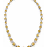 Luxury 18ct white and yellow gold graduated tennis necklace featuring 35 cushion-cut Fancy Yellow diamonds surrounded by white diamond halos, with alternating diamond clusters and a total diamond weight of 20.39ct.