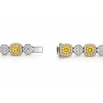 Luxury 18ct white and yellow gold graduated tennis necklace featuring 35 cushion-cut Fancy Yellow diamonds surrounded by white diamond halos, with alternating diamond clusters and a total diamond weight of 20.39ct.