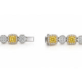 Luxury 18ct white and yellow gold graduated tennis necklace featuring 35 cushion-cut Fancy Yellow diamonds surrounded by white diamond halos, with alternating diamond clusters and a total diamond weight of 20.39ct.