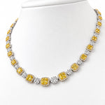 Luxury 18ct white and yellow gold graduated tennis necklace featuring 35 cushion-cut Fancy Yellow diamonds surrounded by white diamond halos, with alternating diamond clusters and a total diamond weight of 20.39ct.