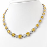 Luxury 18ct white and yellow gold graduated tennis necklace featuring 35 cushion-cut Fancy Yellow diamonds surrounded by white diamond halos, with alternating diamond clusters and a total diamond weight of 20.39ct.