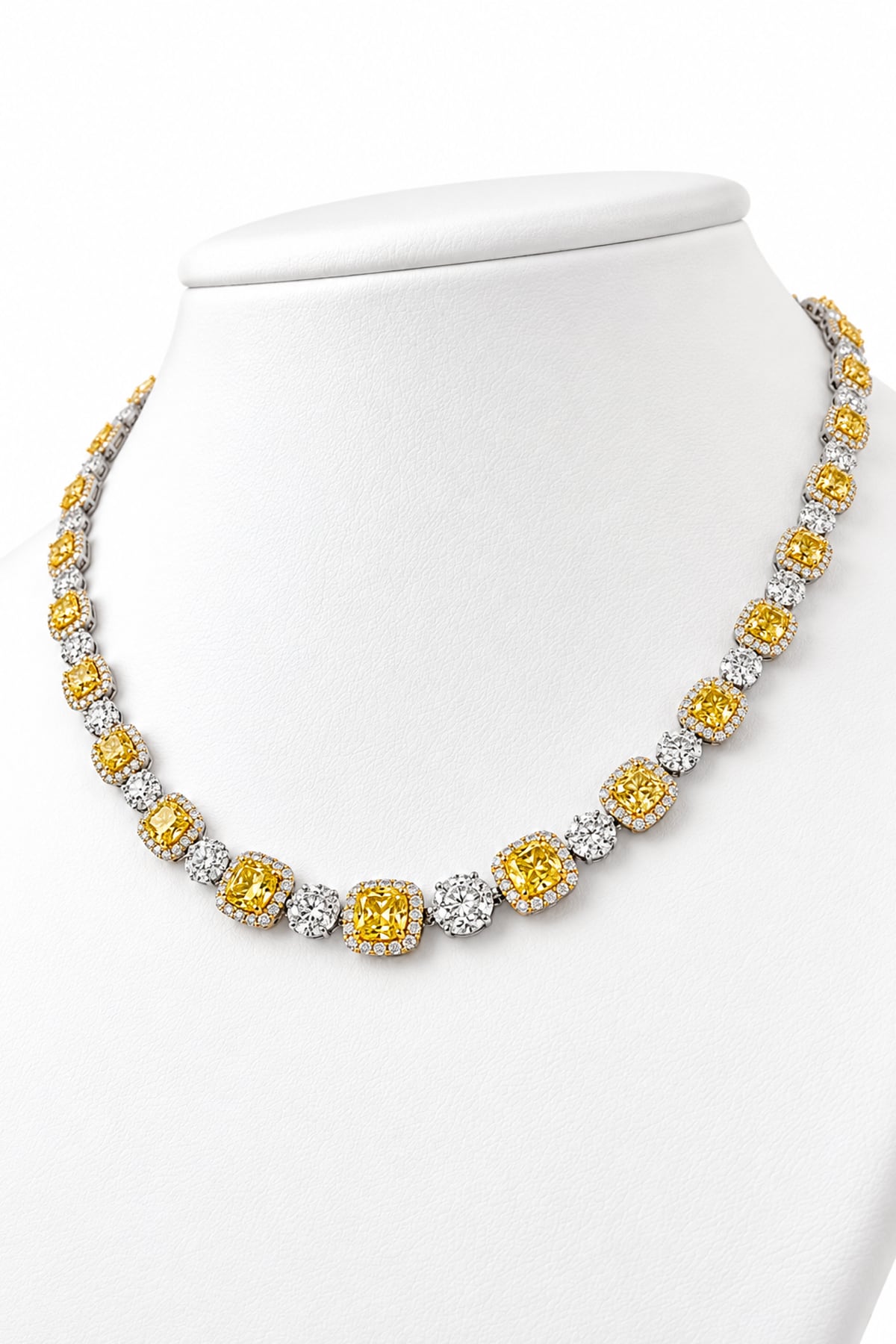 Luxury 18ct white and yellow gold graduated tennis necklace featuring 35 cushion-cut Fancy Yellow diamonds surrounded by white diamond halos, with alternating diamond clusters and a total diamond weight of 20.39ct.